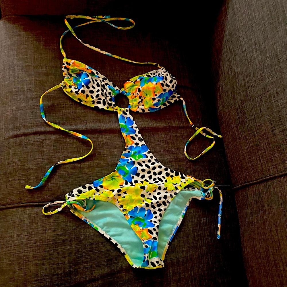 Stylish one piece suit . Never been worn